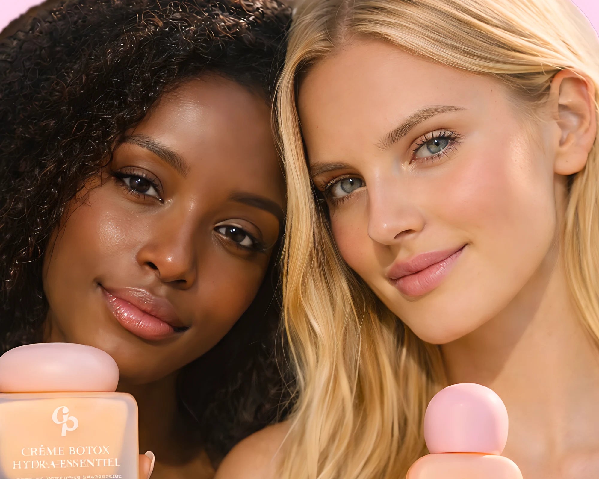 Two smiling women holding the Botox Hydra-Essential cream and the Skin Booster serum